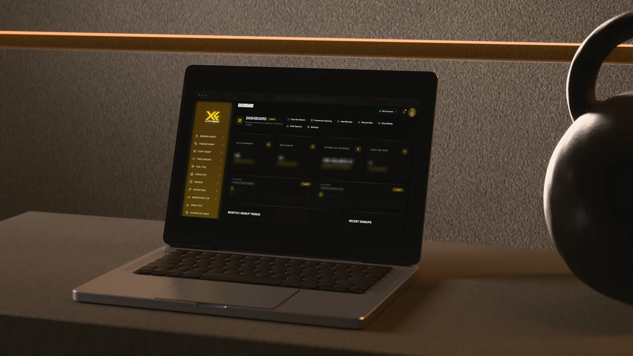 Render: the real XFitness owner dashboard on a rendered laptop, figures blurred