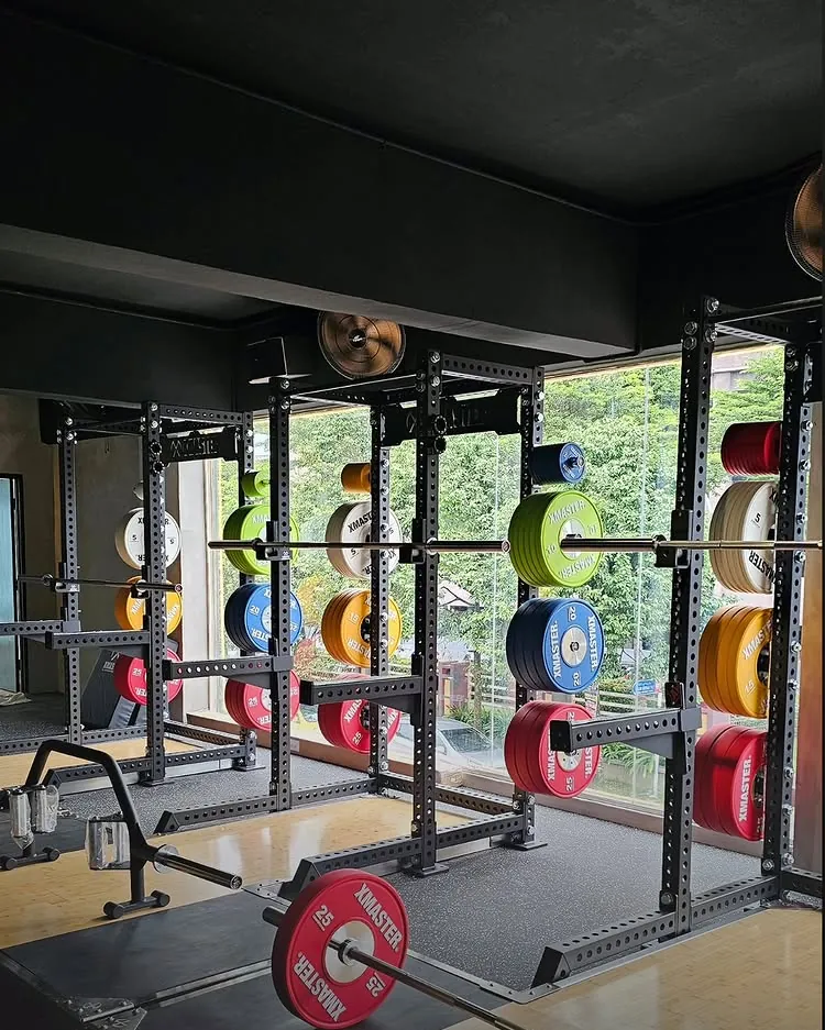Photo, XFitness. Squat racks and bumper plates.